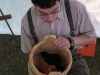 David Salvetti works on a wooden bucket with hand tool